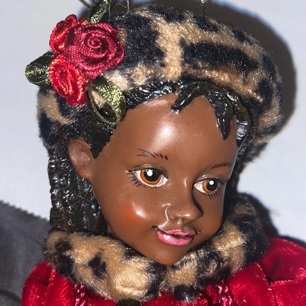 Vintage African American doll ornament with red velvet and leopard fur purse